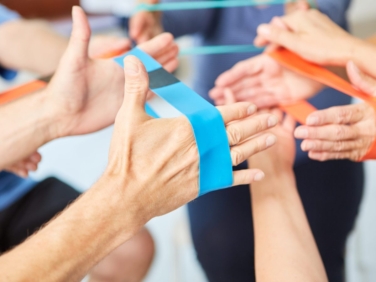 Hands,Do,Exercise,With,The,Elastic,Band,As,Physiotherapy,In